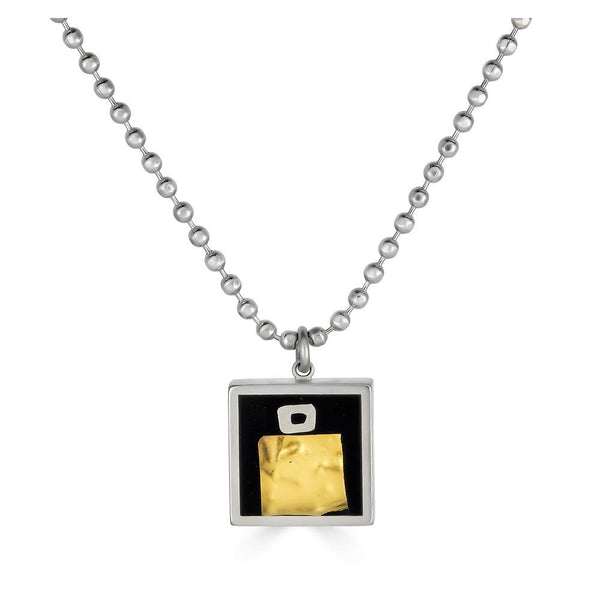 Over & Under Pendant by Ronnie Taubenfeld is handmade with 24K yellow gold-fused Murano glass embedded in black resin and set in a square sterling silver frame, hanging from a silver ball chain.