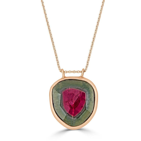 Watermelon Gem Necklace by Ronnie Taubenfeld is a slice of pink and green Watermelon Tourmaline set in 14K gold and hanging by two tiny loops from a gold cable chain.
