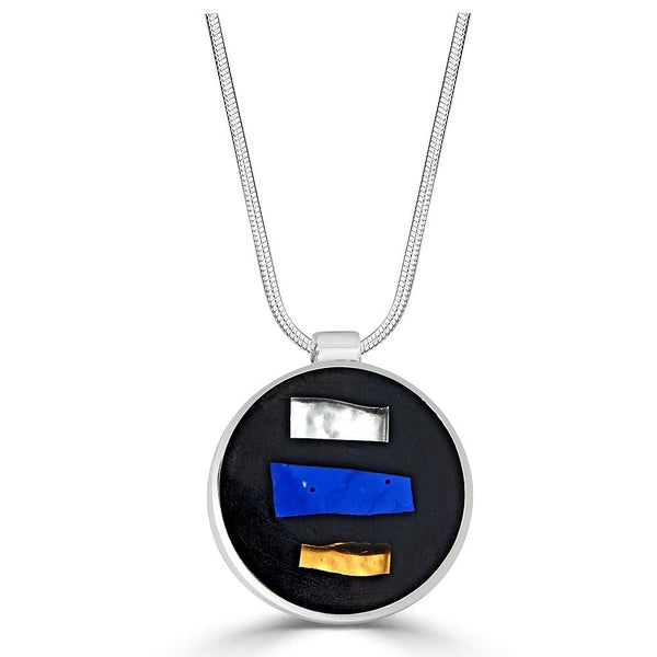 3 Stripes Necklaces Ronnie Taubenfeld is a round silver pendant with silver, gold and blue stripes of glass set in a black resin background hanging for a silver chain