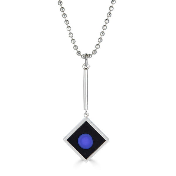 Blue Dot Pendant Ronnie Taubenfeld is a handmade sterling silver square with a blue glass dot set in black resin hanging from a silver chain.