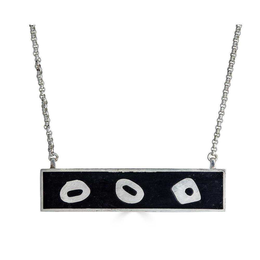 Abstract No.1 Necklace Ronnie Taubenfeld is a silver horizontal bar pendant with abstract organic forms on a black resin background