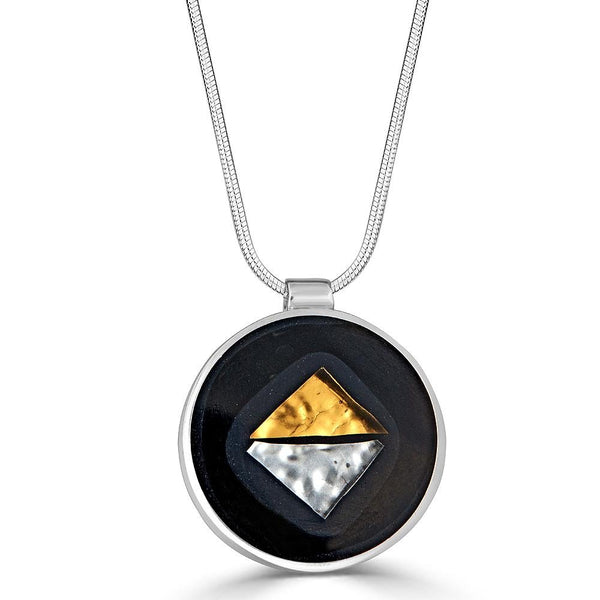 Angle to Angle Pendant Necklaces Ronnie Taubenfeld is a handmade round silver pendant with gold and silver glass triangles set in gray and black resin