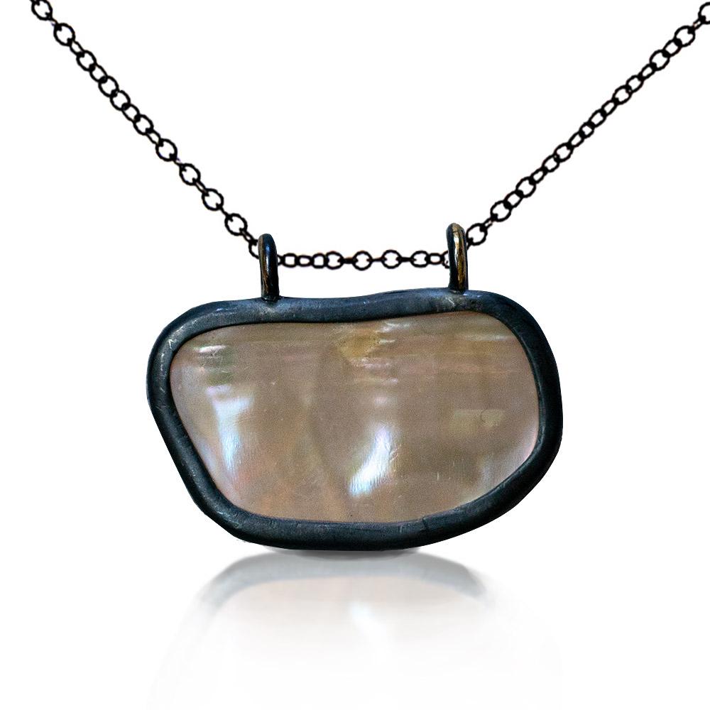 Breeze Necklace by Ronnie Taubenfeld is handmade using mother of pearl set in oxidized sterling silver hanging from a black silver chain