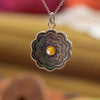 Colorful Zinnia Necklace Ronnie Taubenfeld is handmade using carved mother of pearl with Citrine cabochons set front and back and framed in sterling silver