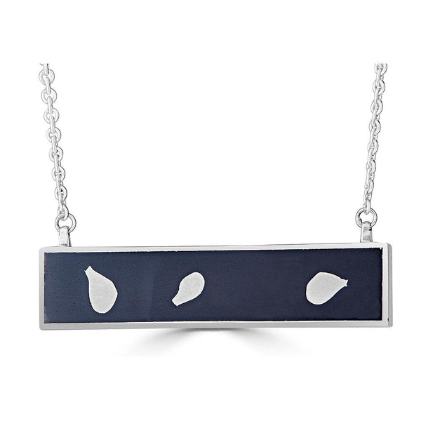 Dancing Leaves Necklaces Ronnie Taubenfeld is a handmade sterling silver bar with sterling leaf shapes embedded in black resin and set in a silver horizontal frame
