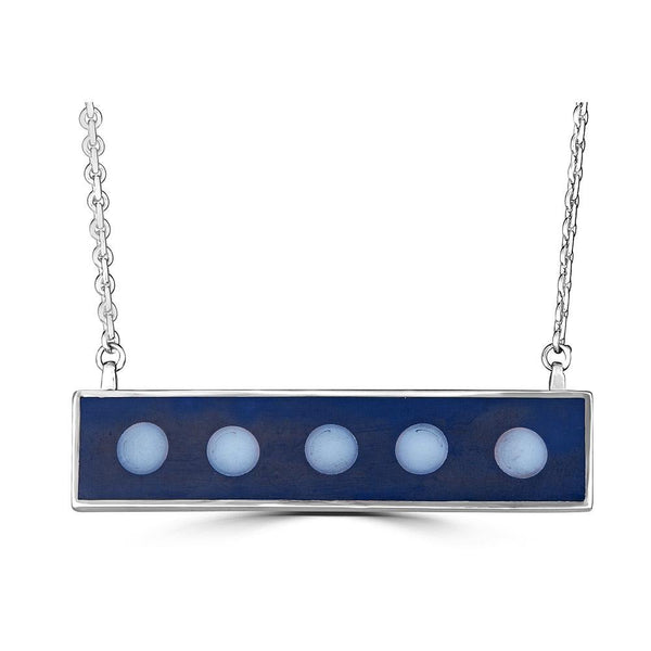 Dots in a Row Necklaces Ronnie Taubenfeld is handmade with six white glass dots embedded in dark gray resin and set in a horizontal sterling silver bar shape.