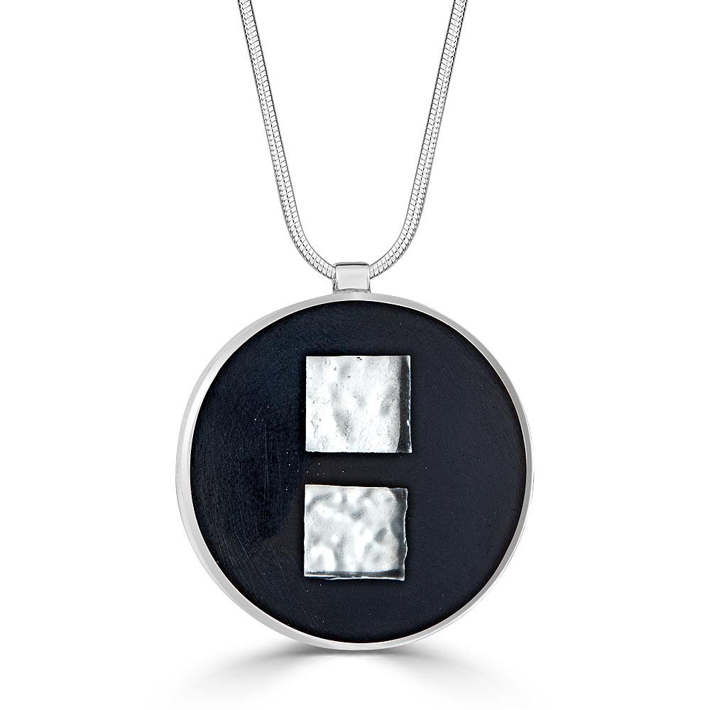 Double or Nothing Necklaces Ronnie Taubenfeld is handmade from 24k white gold-fused Murano glass squares embedded in black handpoured resin and set in a round sterling silver frame