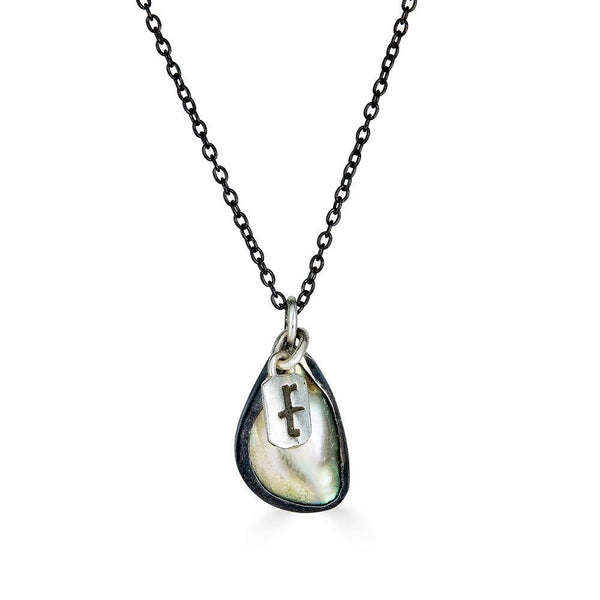 Flow Necklaces Ronnie Taubenfeld  is a handset iridescent oval of mother of pearl in an oxidized silver setting with an bright silver RT logo hanging alongside