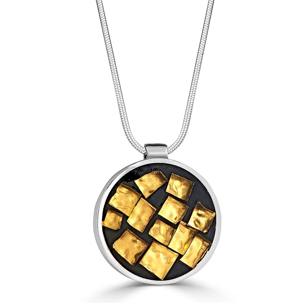Gold Nuggets Necklaces Ronnie Taubenfeld has many tiny squares of gold Murano glass embedded in black resin and handset in a sterling silver round frame hanging from a silver snake chain