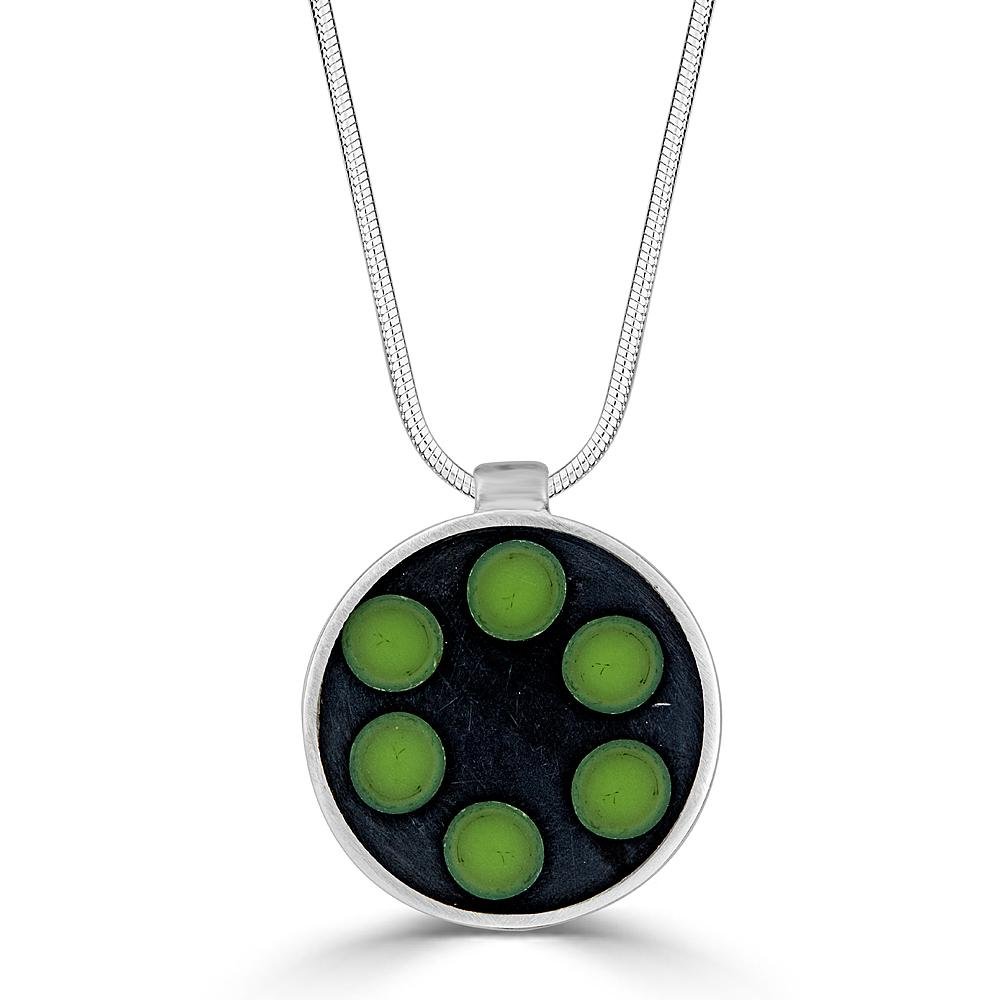 Green Dial Necklaces Ronnie Taubenfeld has six green glass dots arranged like a dial embedded in black resin and set in a sterling silver round frame, hanging from a silver snake chain. Handmade.