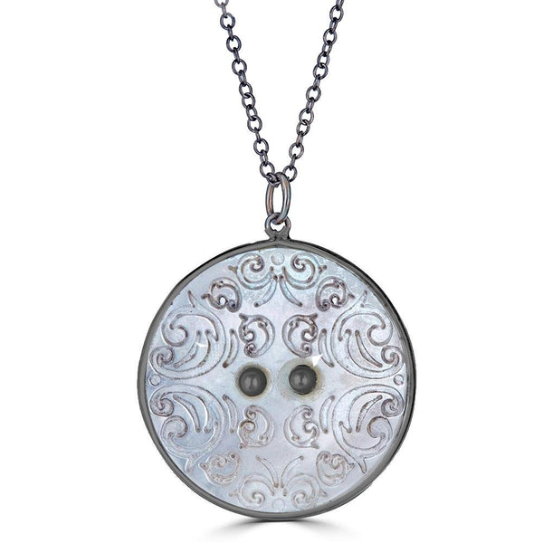 Intricacy Necklaces Ronnie Taubenfeld is a limited edition mother of pearl button set in oxidized sterling silver hanging from a black silver cable chain. Handmade.