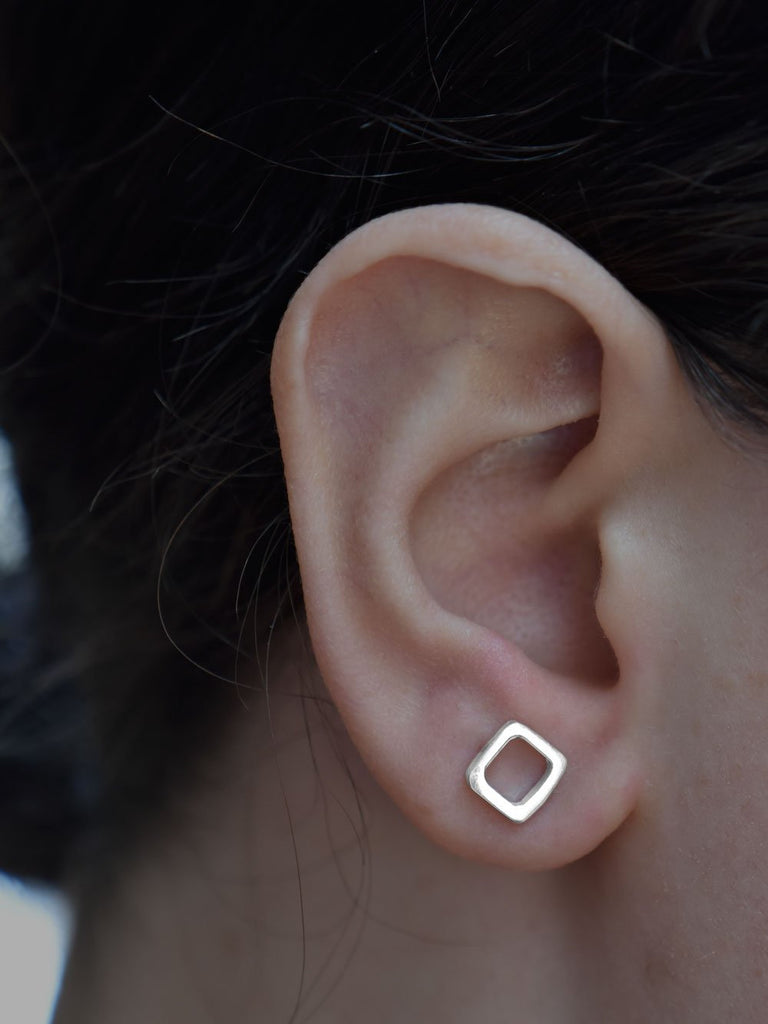 Jingbo Studs Earrings Ronnie Taubenfeld shown on a woman's ear for size.