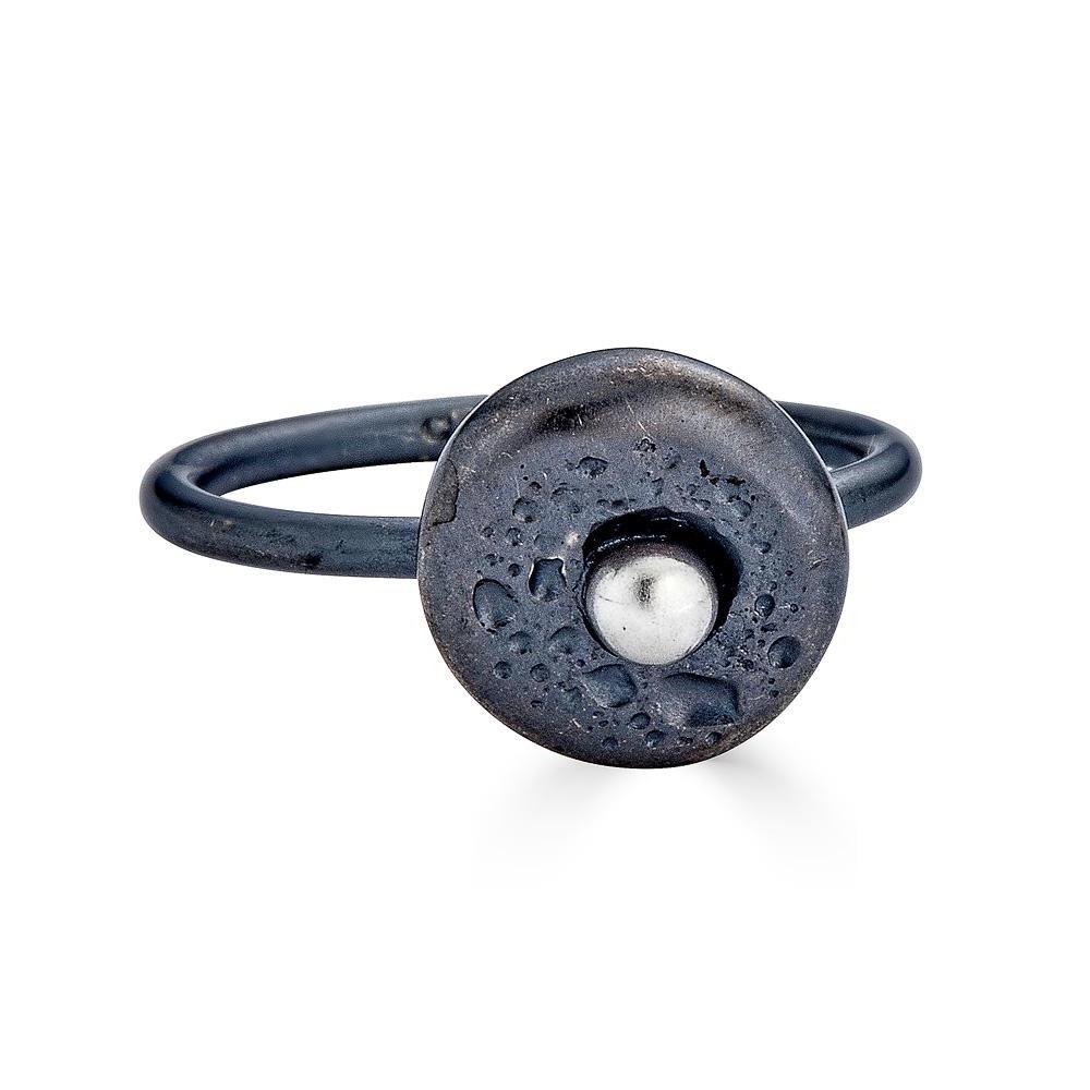 Moonscape Rings Ronnie Taubenfeld is handmade from oxidized sterling silver and has a flattened textured round shape with a bright silver ball in the center.