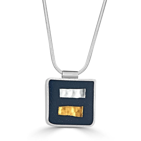 Opposites Attract Necklace by Ronnie Taubenfeld is handmade with 24k white and yellow gold fused to Murano glass and embedded in dark resin, set in a sterling silver frame.