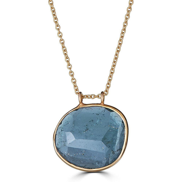Sea of Blue Necklace by Ronnie Taubenfeld is an oval shaped sea blue faceted Tourmaline set in 14K yellow gold hanging from a gold cable chain.