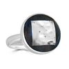 Silver Rush Ring by Ronnie Taubenfeld is a handmade sterling silver round setting framing a 24k white gold-fused Murano glass square embedded in black resin.