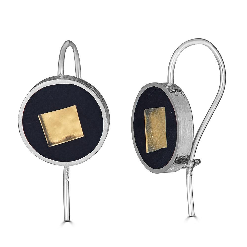 Square in a Circle Drop Earrings by Ronnie Taubenfeld are sterling silver self-locking disks with a 24K yellow gold-fused glass smalto embedded in black resin and set within.