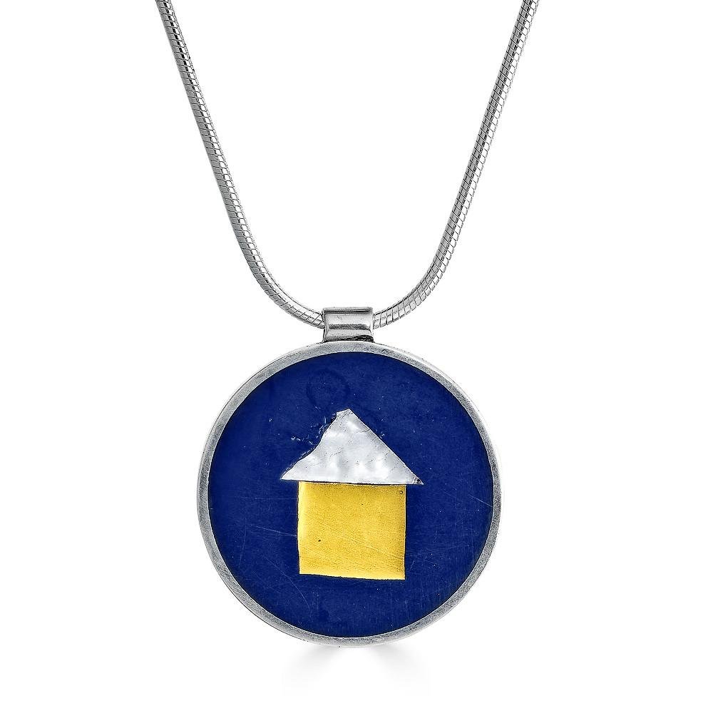 Tiny House Necklace by Ronnie Taubenfeld is a gold fused square of Murano glass covered by silver glass triangular roof, embedded in black resin and set in a circular sterling silver frame, hanging from a silver snake chain.