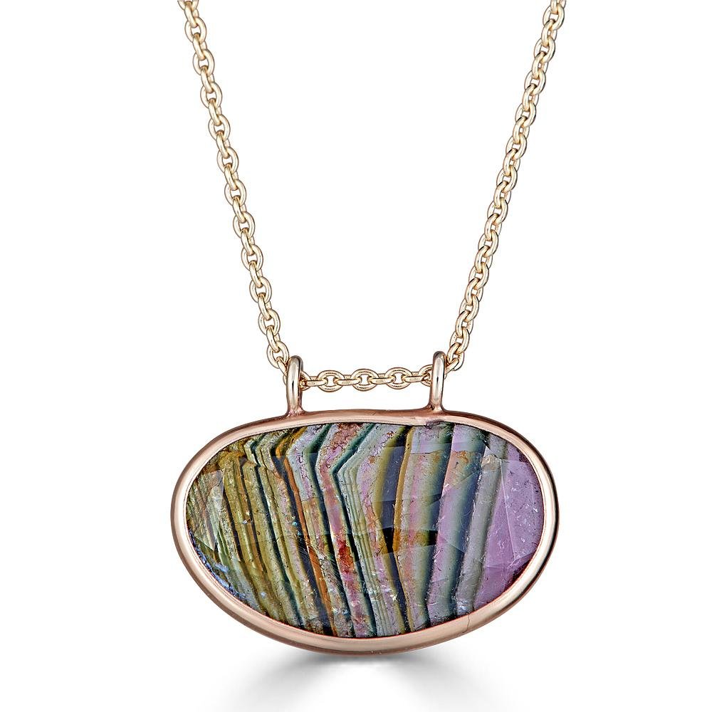 Vertical Stripes Gem Necklaces Ronnie Taubenfeld is a striped Watermelon Tourmaline faceted oval gem channel set in 14K yellow gold, hanging from a gold cable chain by two tiny loops.