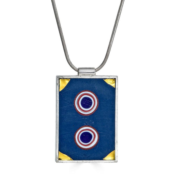 Vienna Necklace by Ronnie Taubenfeld is a silver rectangular frame with two bullseye slices of glass and gold triangular glass corners set in dark gray resin, hanging from a silver snake chain.
