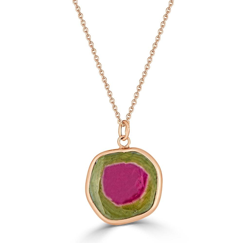 Watermelon Slice Gem Necklace by Ronnie Taubenfeld is a slice of pink and green Watermelon Tourmaline set in 14K gold and hanging from a gold cable chain.